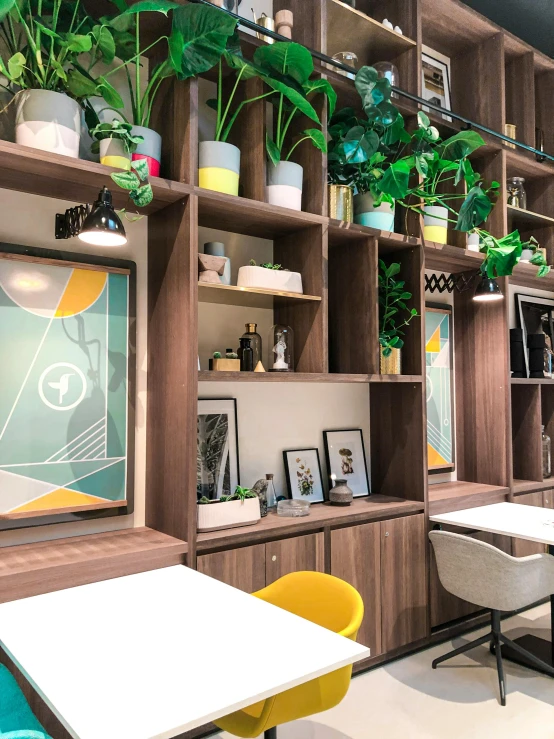 a room filled with lots of tables and chairs, poster art, by Robbie Trevino, unsplash, verdant plant wall, behance lemanoosh, capsule hotel, white and yellow scheme