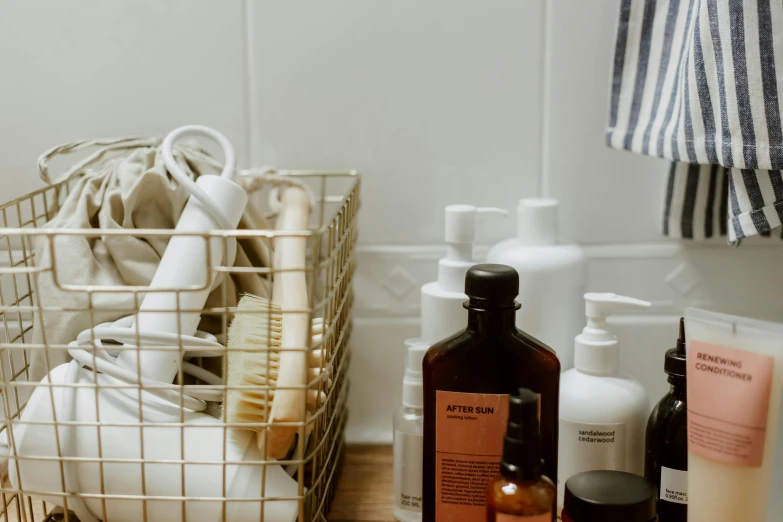a basket full of personal care items on a bathroom counter, by Julia Pishtar, trending on pexels, brown and white color scheme, profile image, fan favorite, bottles covered in wax