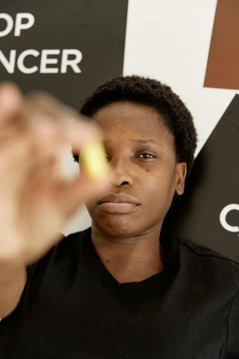 a woman holding a banana in front of a stop cancer sign, by artist, pexels contest winner, renaissance, african facial features, with anamorphic lenses, black teenage boy, high angle close up shot