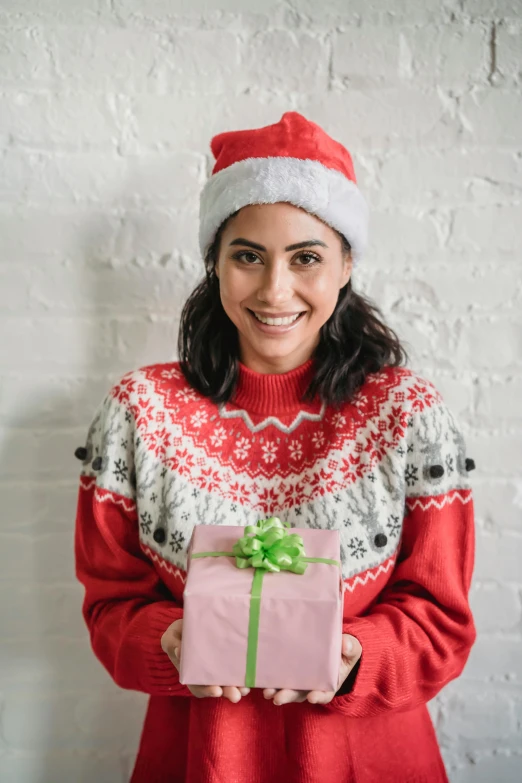 a woman in a santa hat holding a present, a portrait, pexels contest winner, hurufiyya, wearing casual sweater, square, gif, betty la fea