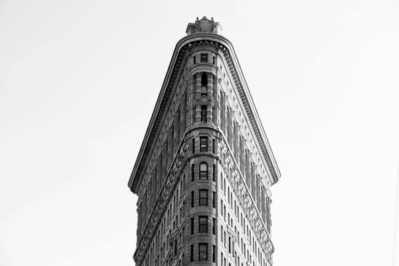 a black and white photo of a tall building, by Andrew Domachowski, unsplash contest winner, art nouveau, platon, new york, viewed from the side, flattened