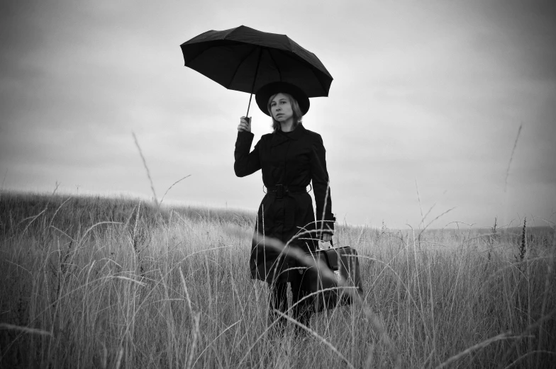 a woman standing in a field holding an umbrella, black stetson and coat, danila tkachenko, recital, prairie