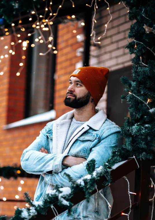 a man standing in front of a christmas tree, by Julia Pishtar, pexels contest winner, beanie hat, well-groomed model, avatar image, maxim sukharev