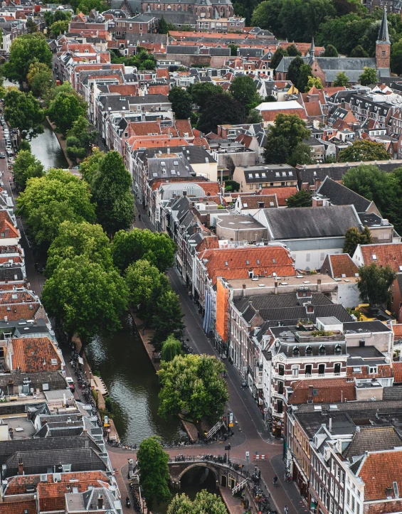 an aerial view of a city with a river running through it, by Jacob Toorenvliet, white buildings with red roofs, utrecht, lgbtq, banner