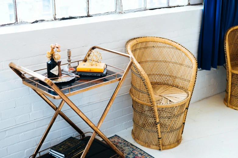 a wicker chair sitting in front of a window, renaissance, gold and black color scheme, tabletop, commercially ready, inspo
