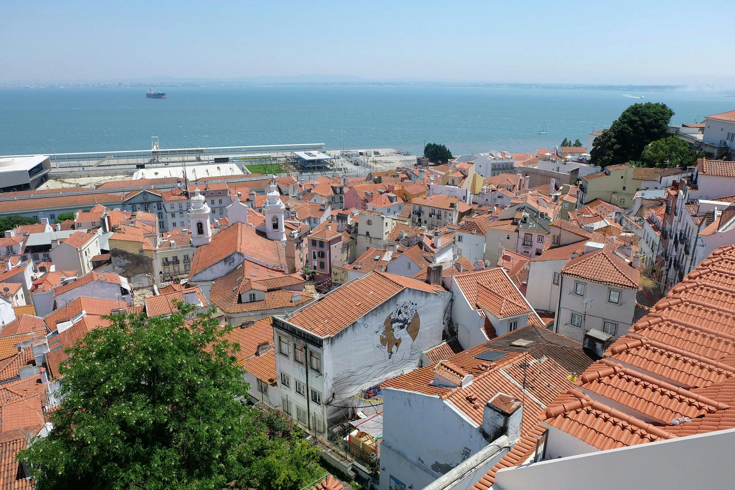 a view of a city from the top of a building, inspired by Almada Negreiros, white buildings with red roofs, slide show, seaview, square