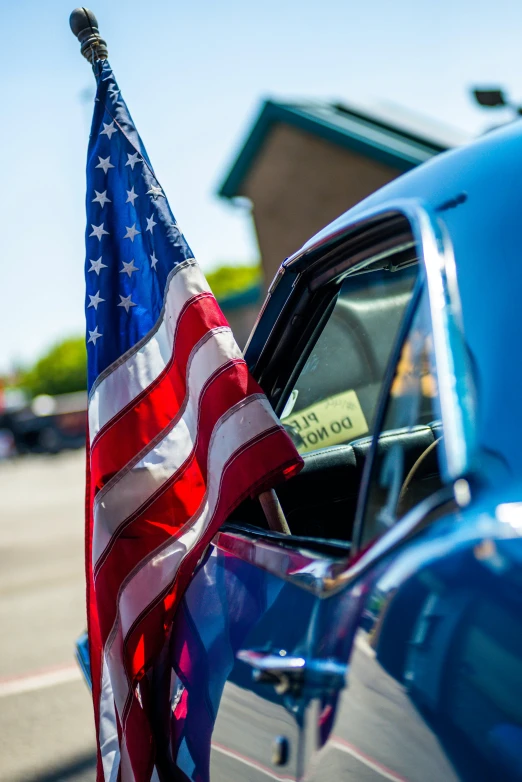 an american flag sticking out of the window of a car, a photo, by Dave Melvin, unsplash, muscle cars, square, on display, celebration