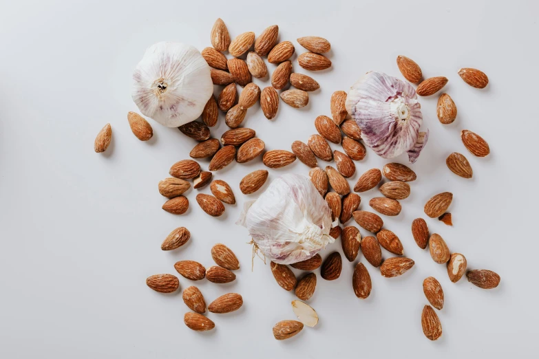 garlic, almonds and garlic on a white surface, by Carey Morris, trending on pexels, product view, 6 pack, beans, listing image