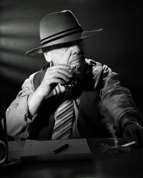 a black and white photo of a man eating a sandwich, a black and white photo, inspired by Yousuf Karsh, pexels contest winner, noir detective and a fedora, praying with tobacco, drinking whiskey, sitting at his desk