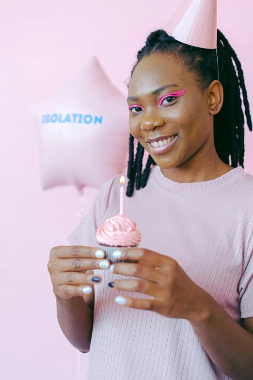 a woman holding a cupcake in front of a pink background, by Dulah Marie Evans, trending on unsplash, barbarian celebrate his birthday, black teenage boy, waxy candles, 🍸🍋