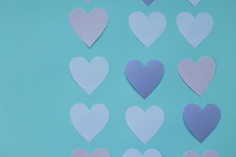 a bunch of paper hearts on a blue background, by Carey Morris, trending on pexels, purple blue color scheme, thumbnail, pale blue skin, background image