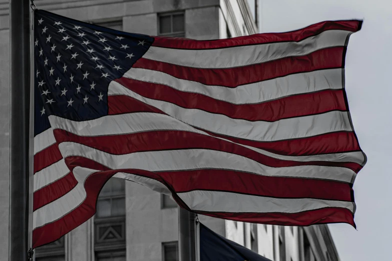 an american flag flying in front of a building, a photo, pexels contest winner, desaturated, banner, colors red white blue and black, celebration