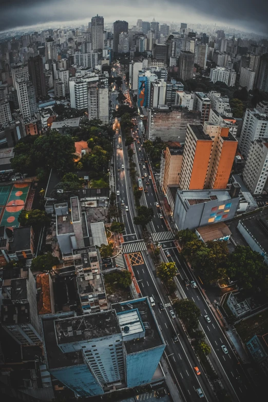 an aerial view of a city at night, pexels contest winner, avenida paulista, houses and roads, square, city morning