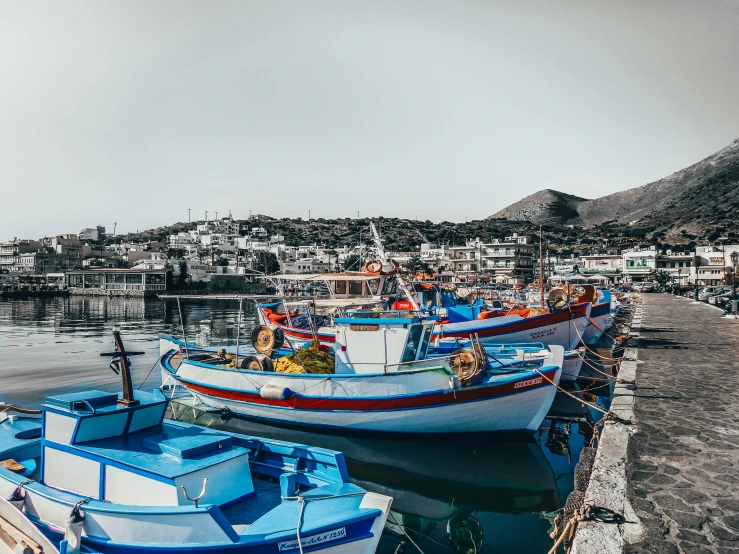 a couple of boats that are sitting in the water, pexels contest winner, greek ethnicity, fish market, avatar image, 🚿🗝📝