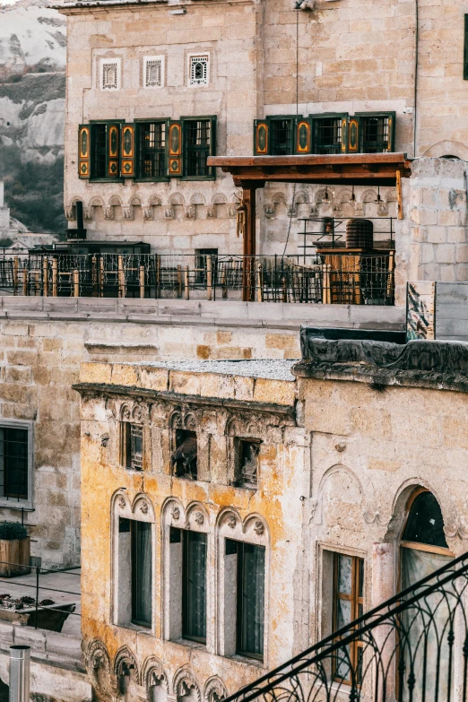 a couple of buildings that are next to each other, by Riad Beyrouti, trending on pexels, renaissance, conversano, balcony scene, damascus, unfinished