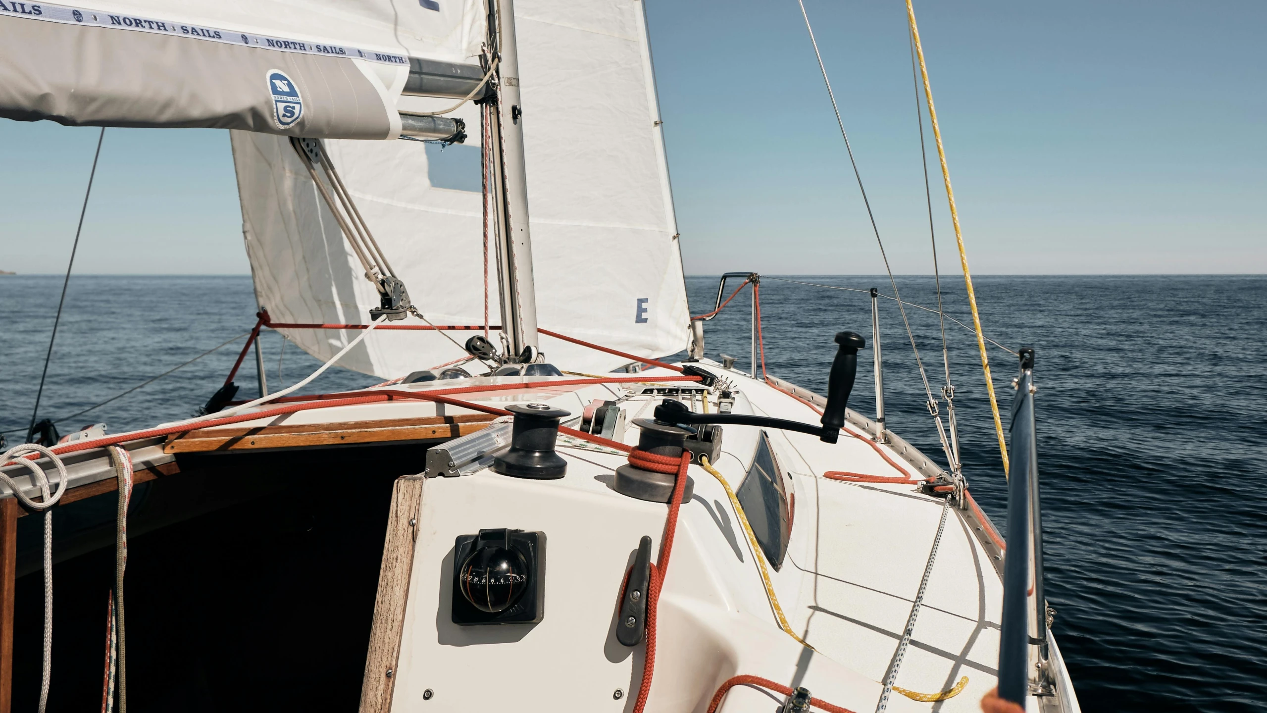 a sail boat in the middle of the ocean, a portrait, unsplash, cockpit, close - up profile, high quality photo, ignant