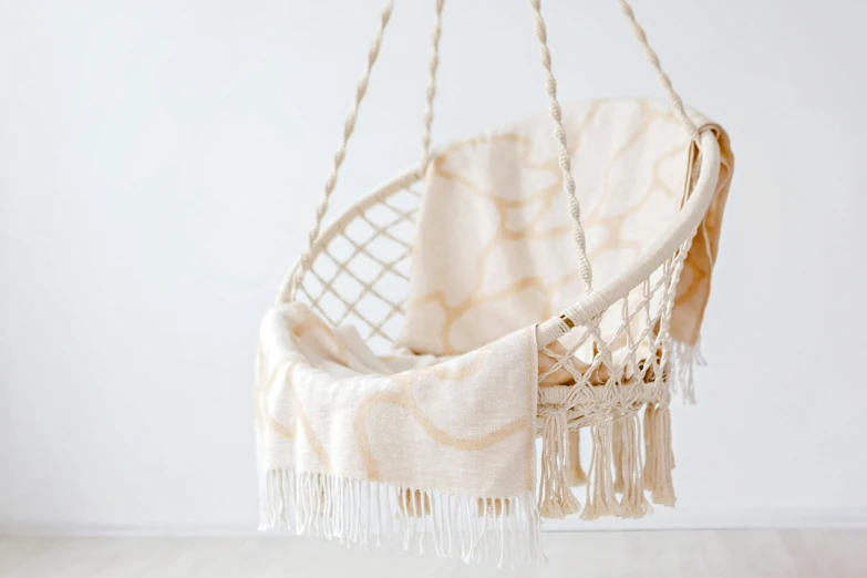 a hammock chair hanging from a rope, arabesque, white and gold, armchairs, vanilla, simplistic