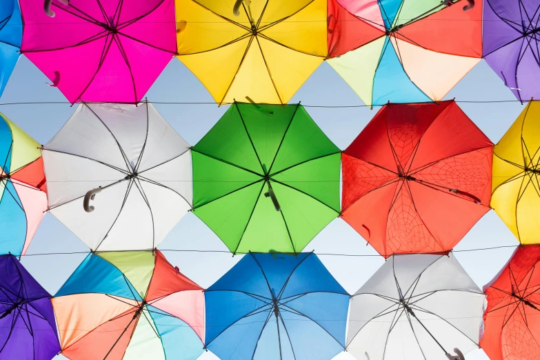 a bunch of colorful umbrellas hanging from a wire, trending on unsplash, precisionism, geometrically correct, multiple stories, full width, colorful caparisons