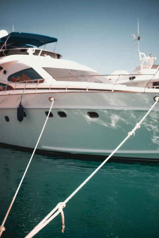 a couple of boats that are in the water, up close, super smooth lines, floating power cables, red sea