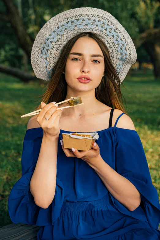 a woman sitting on a bench eating a bowl of food, trending on pexels, renaissance, japanese model, wearing straw hat, avatar image, blue