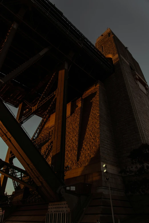 a couple of people that are standing under a bridge, pexels contest winner, australian tonalism, big towers, 4 k detail, industrial colours, dramatic lighting - n 9