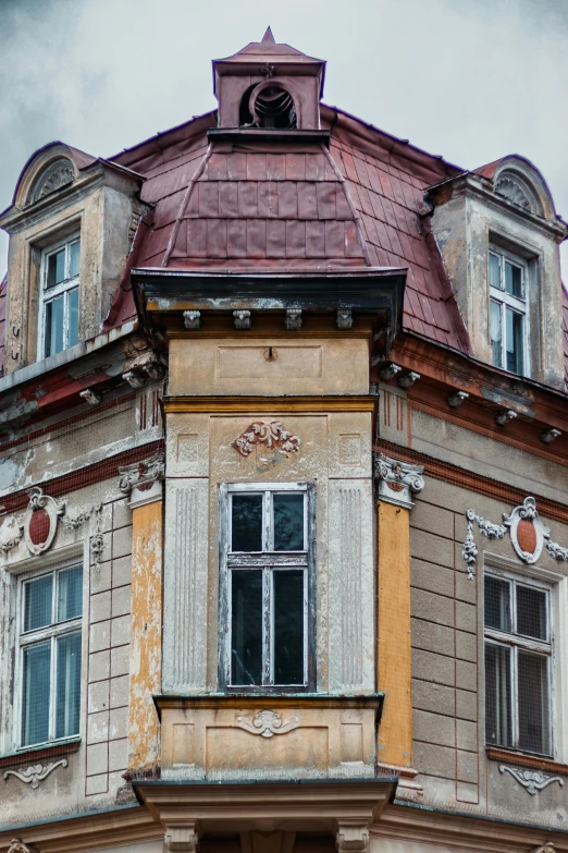 a tall building with a clock on top of it, inspired by Gyula Aggházy, art nouveau, weathered surfaces, bay window, shot from roofline, turrets