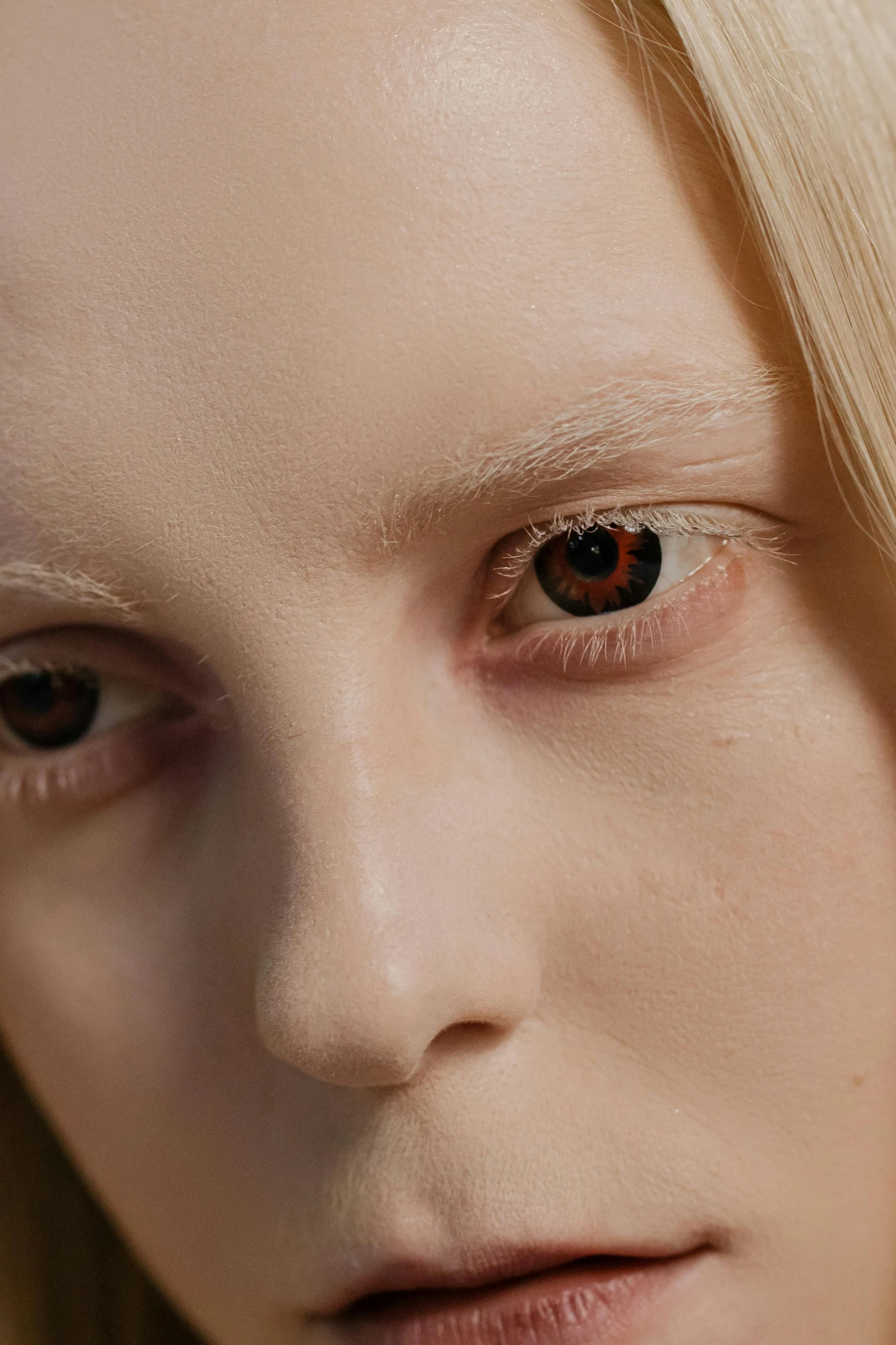 a close up of a person with blonde hair, inspired by Vanessa Beecroft, trending on pexels, prosthetic eyeballs, black eyed kids, with amber eyes, red contact lenses