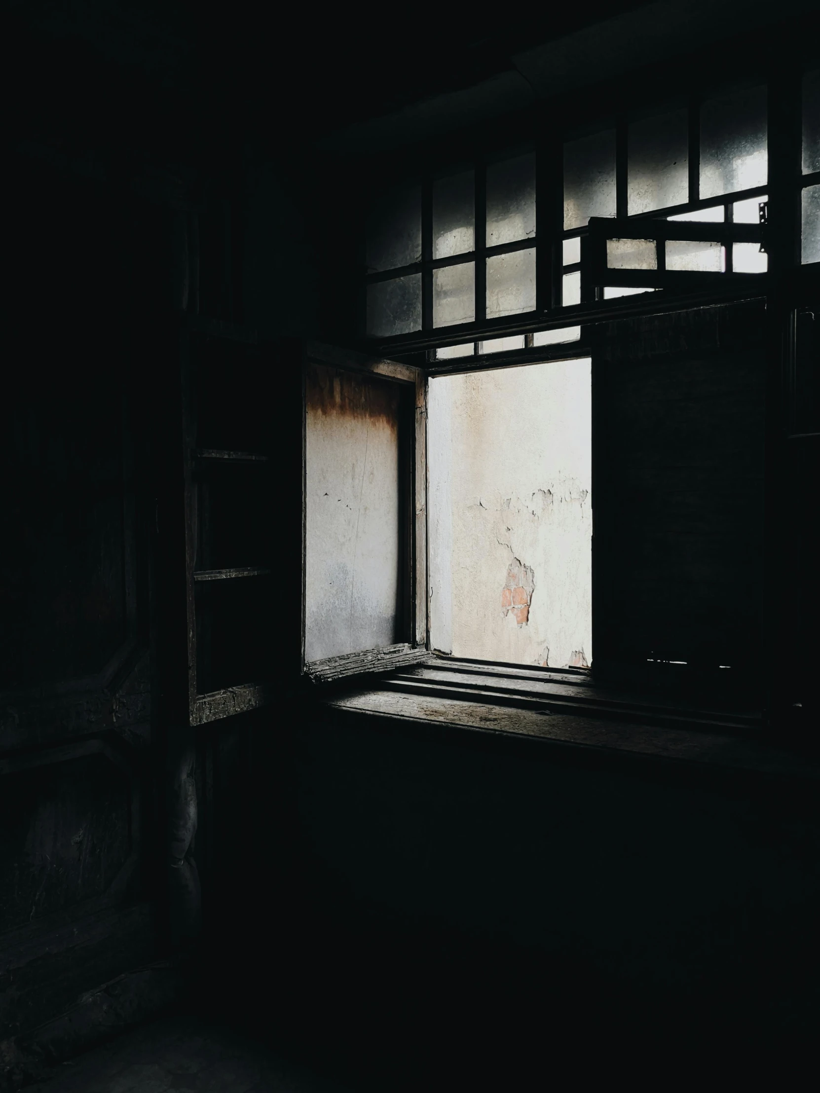 a black and white photo of a window in a dark room, a picture, inspired by Elsa Bleda, unsplash contest winner, hashima island, photo on iphone, dusty library, an escape room in a small