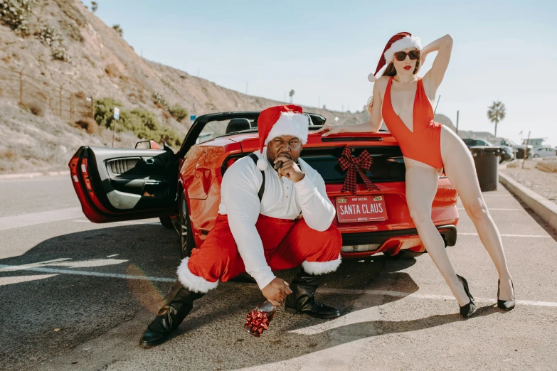 a man and a woman posing in front of a car, by Ryan Pancoast, pexels contest winner, santa clause, playboy centerfold, huell babineaux, winston from overwatch