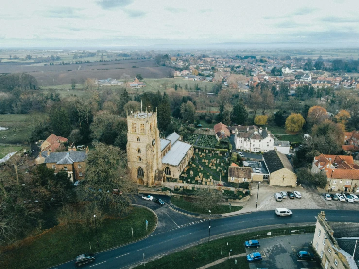 a view of a town from the top of a tower, by IAN SPRIGGS, unsplash contest winner, mayfield parish, aerial shot from the drone, church, exterior shot