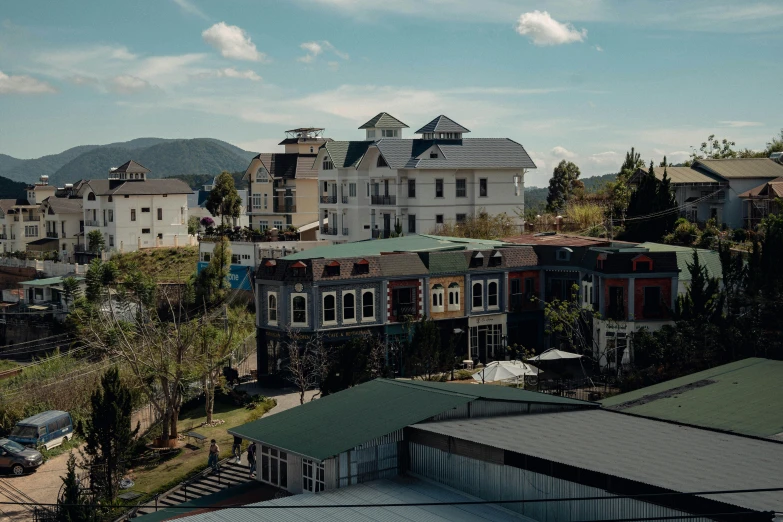 a view of a town from the top of a hill, a portrait, unsplash, quito school, ai weiwei and gregory crewdson, exterior view, manuka, house's and shops and buildings