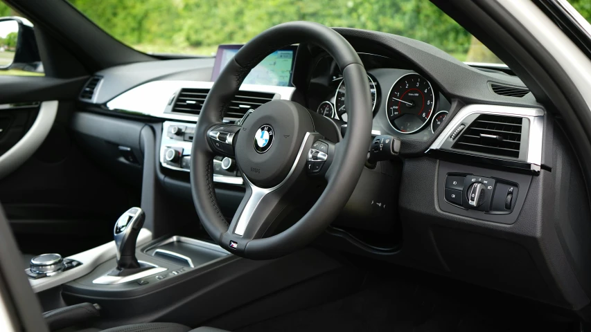 a close up of a steering wheel in a car, by Tom Bonson, unsplash, bmw, interior of a small, pristine and clean, f4”