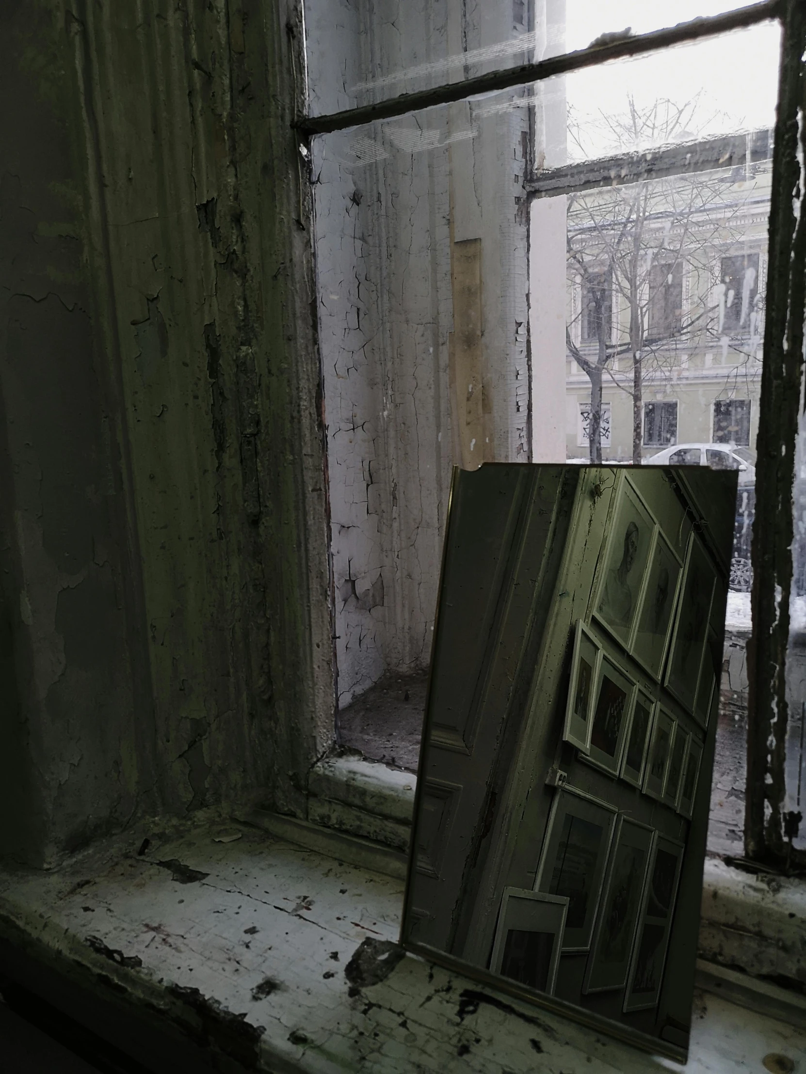 a mirror sitting on top of a window sill, an album cover, hyperrealism, in tarkov, low quality photo, derelict, snapchat photo