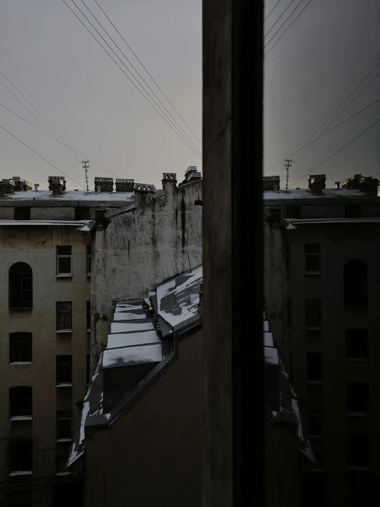 a view of a city from a window, an album cover, inspired by Elsa Bleda, unsplash contest winner, saint petersburg, the sky is gray, low quality photo, alleys