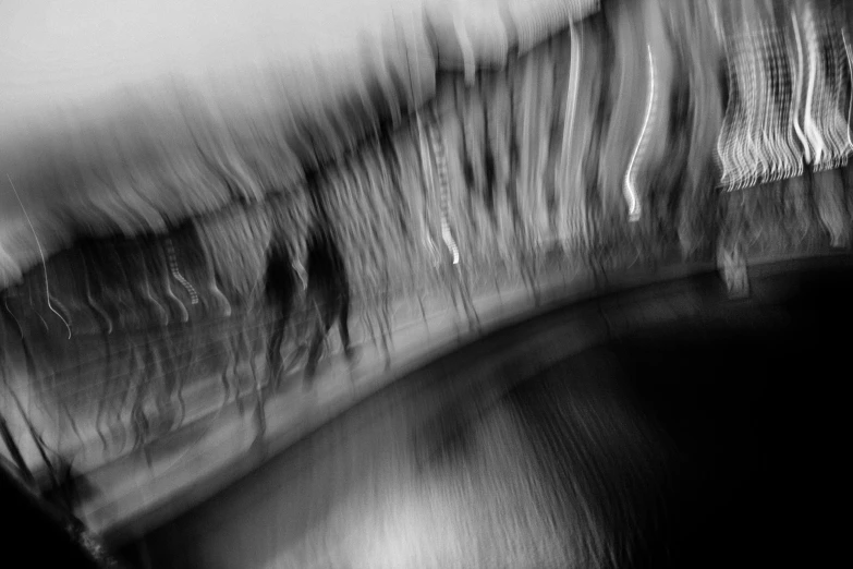 a blurry photo of people walking across a bridge, a black and white photo, by Mirko Rački, lyrical abstraction, night. by greg rutkowski, abstract liquid, sergey krasovskiy, maxim shirkov