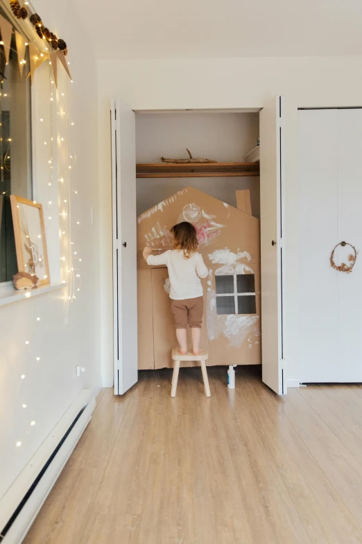 a little girl standing on a stool in a room, opening door, designed for cozy aesthetics!, kai carpenter, profile image