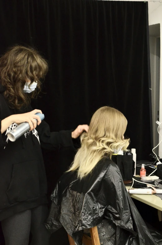 a woman cutting another woman's hair with a blow dryer, by Sara Saftleven, trending on reddit, fashionweek backstage, wavy blond hair, long shot from back, hair made of shimmering ghosts