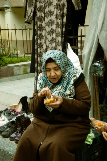 a couple of women sitting next to each other eating food, inspired by Modest Urgell, hurufiyya, crafts and souvenirs, square, donut, from egypt
