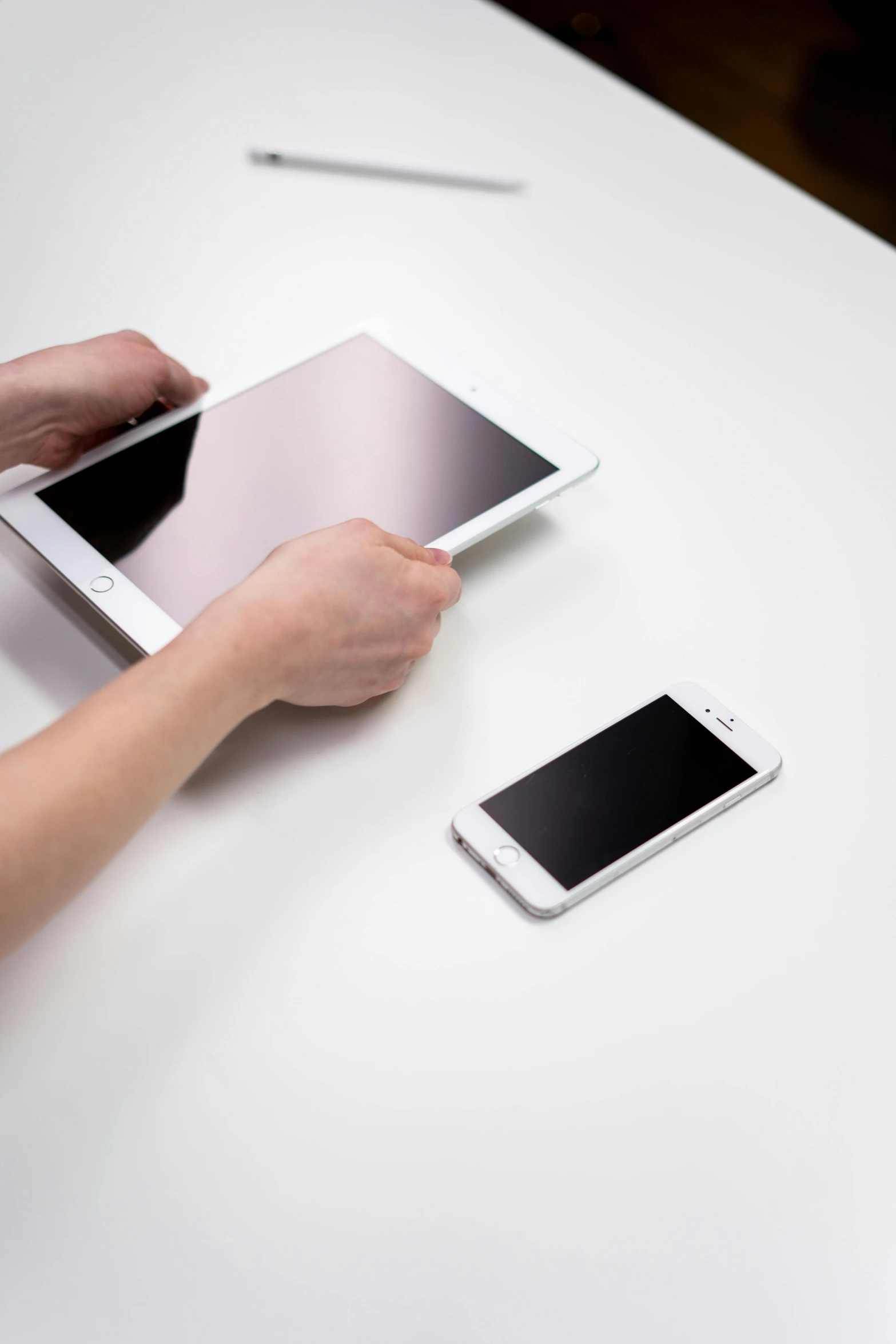 a person sitting at a table using a tablet computer, by Matthias Stom, trending on pexels, 2 5 6 x 2 5 6 pixels, cell phones, assembly instructions, white backround