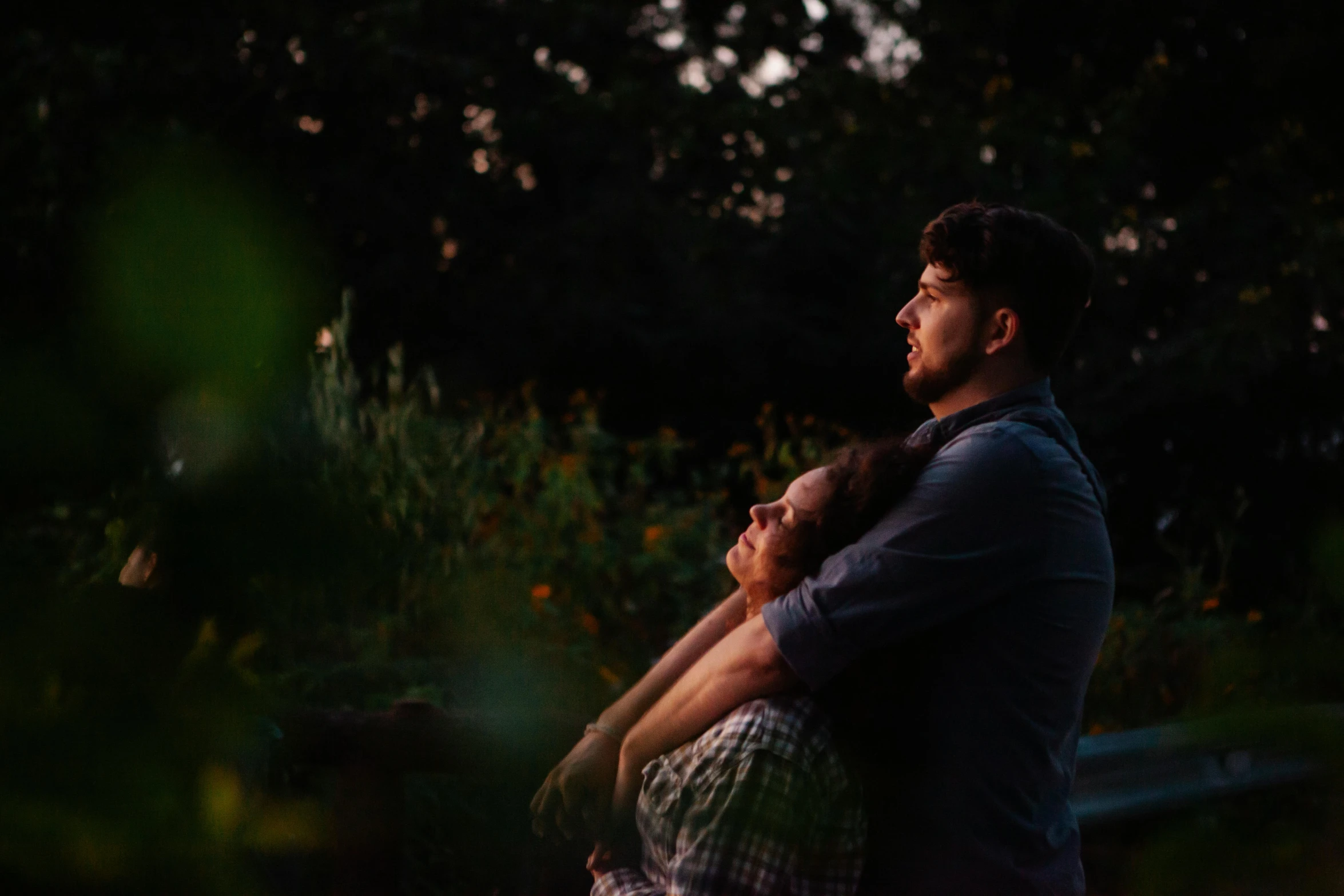 a man holding a woman in his arms, pexels contest winner, late summer evening, looking off to the side, cinematic footage, # film