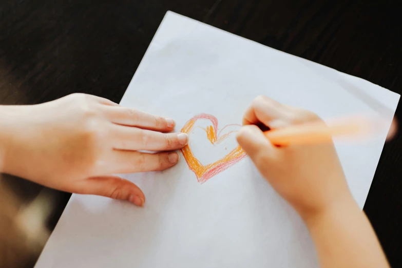 a child drawing a heart on a piece of paper, a child's drawing, by Emma Andijewska, pexels contest winner, thumbnail, flat coloring, love craft, opening shot