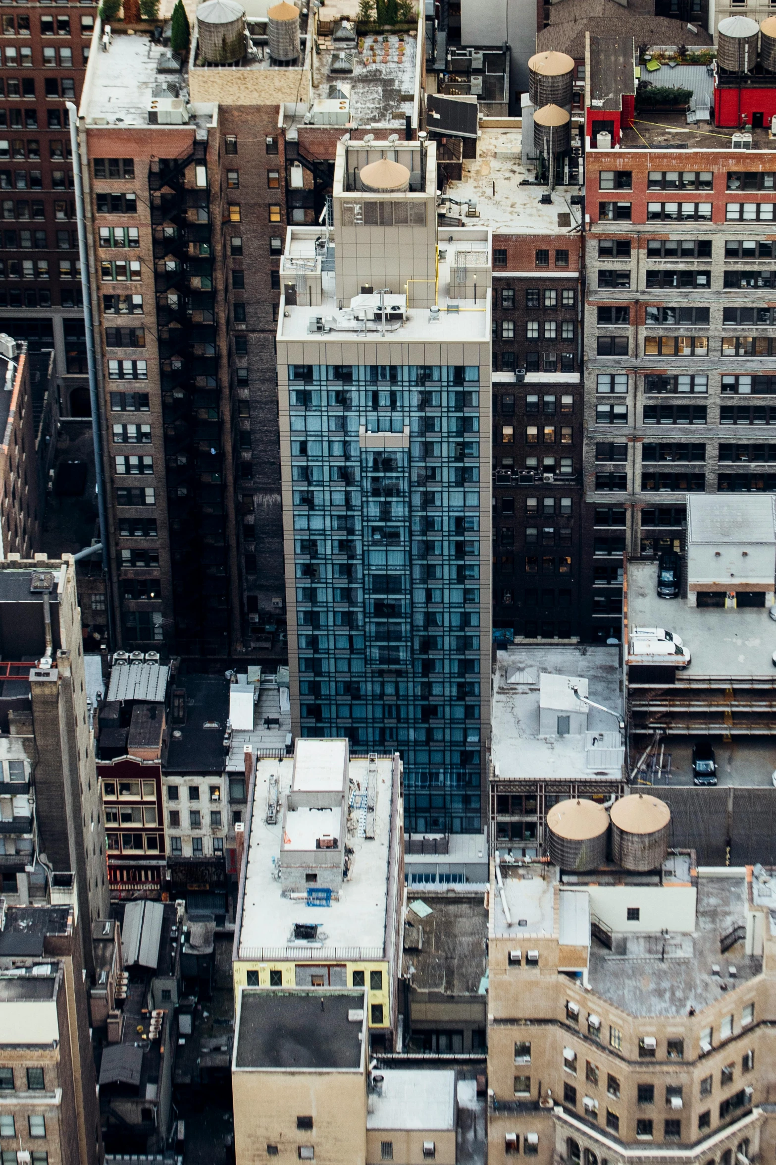 a view of a city from the top of a building, by Dan Christensen, pexels contest winner, modernism, compact buildings, sins inc skyscraper front, single building, 8 k high resolution image