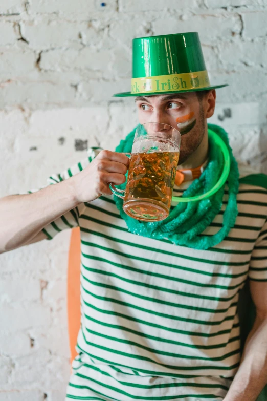 a man in a green hat drinking a beer, pexels contest winner, renaissance, striped, escherichia coli party, a handsome, celtics