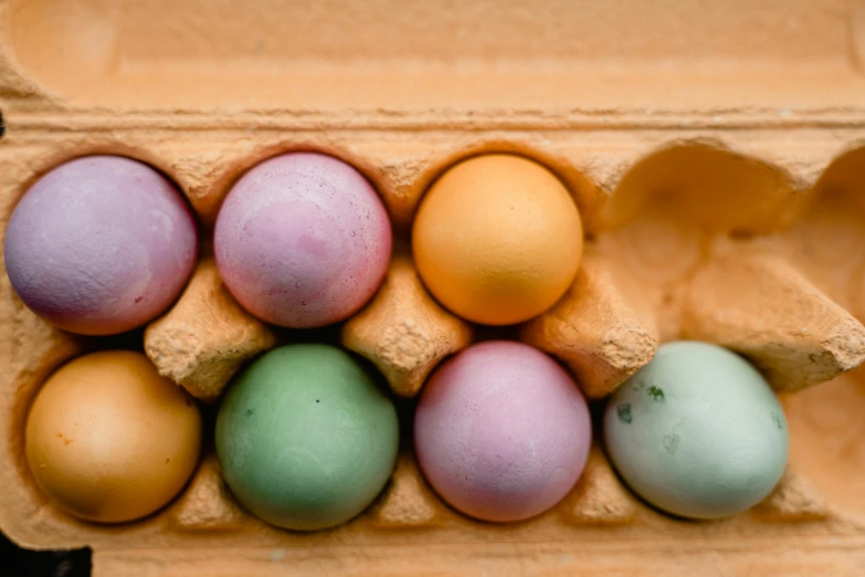a carton filled with lots of different colored eggs, a pastel, by Jan Tengnagel, trending on unsplash, berries inside structure, shot on sony a 7 iii, bottom body close up, thumbnail