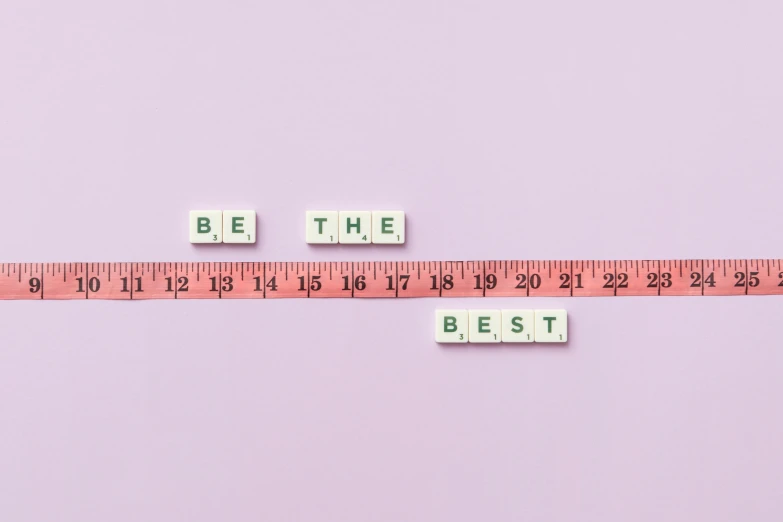 a measuring tape with the words be the best on it, by Emma Andijewska, aestheticism, y2k aesthetic, smallest waistline, mental health, set pieces