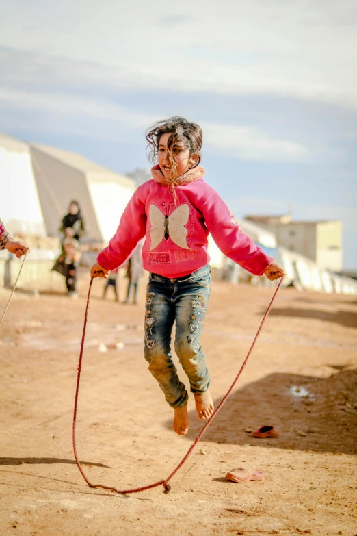 a young girl jumping with a jump rope, by Daren Bader, hurufiyya, refugees, pink, slide show, 8k 4k