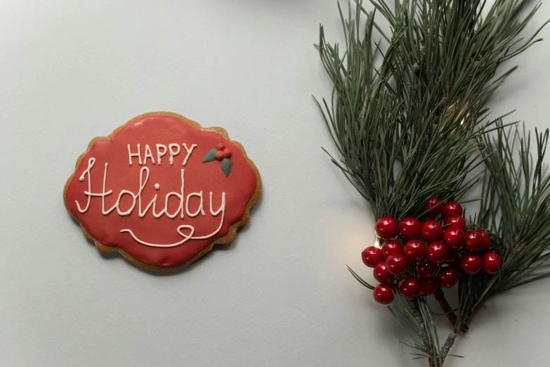 a close up of a cookie on a table, by Emma Andijewska, pexels, graffiti, merry, background image, ornament, red writing