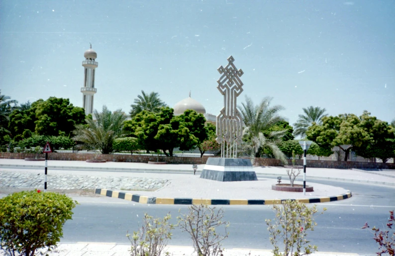 there is a statue in the middle of the road, a colorized photo, hurufiyya, sheik mohammad ruler of dubai, churchyard, with an intricate, plaza