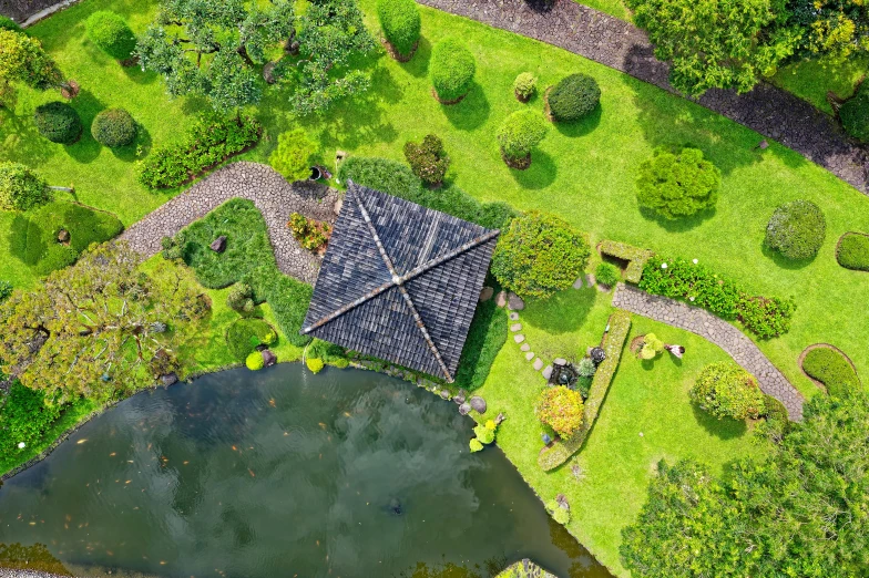 an aerial view of a garden with a pond, inspired by Itō Jakuchū, pexels contest winner, thatched roof, pyramid surrounded with greenery, professionally post-processed, grey