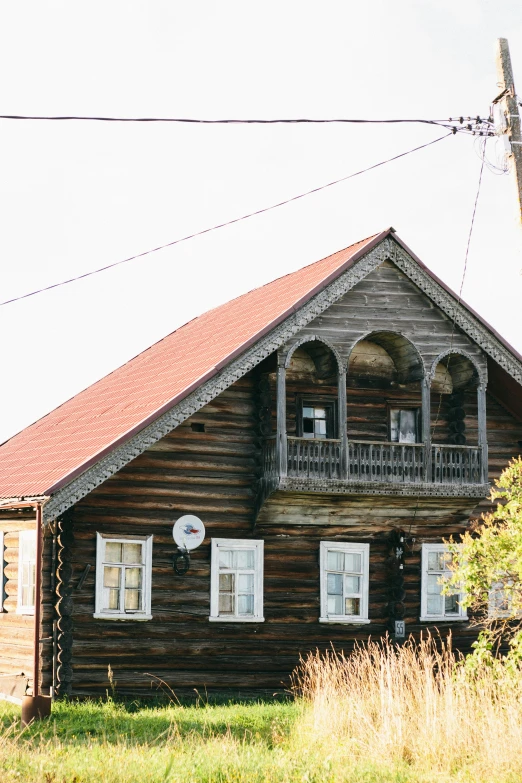 a wooden house sitting on top of a lush green field, inspired by Isaac Levitan, unsplash, renaissance, soviet town, 000 — википедия, exterior view, front profile